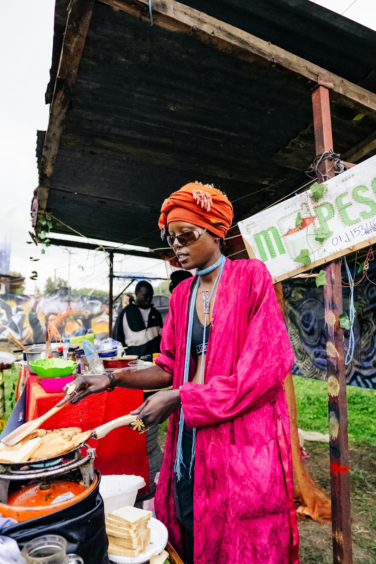 Food vendor cooking chapati at a street stall in Kenya, colourful cooking scene