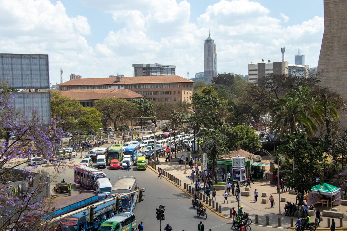 Busy city street in Nairobi Kenya with colourful buses and pedestrians, East Africa urban scene
