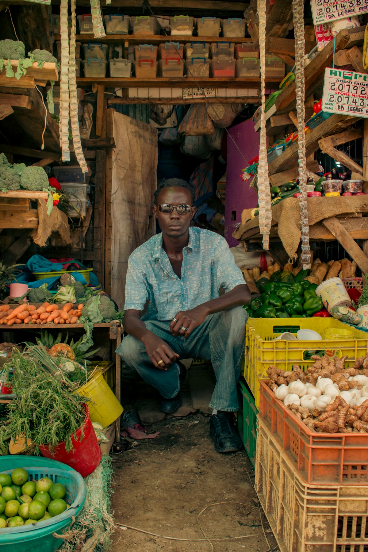 Market vendor selling fresh vegetables and produce at a Nairobi Kenya market stall