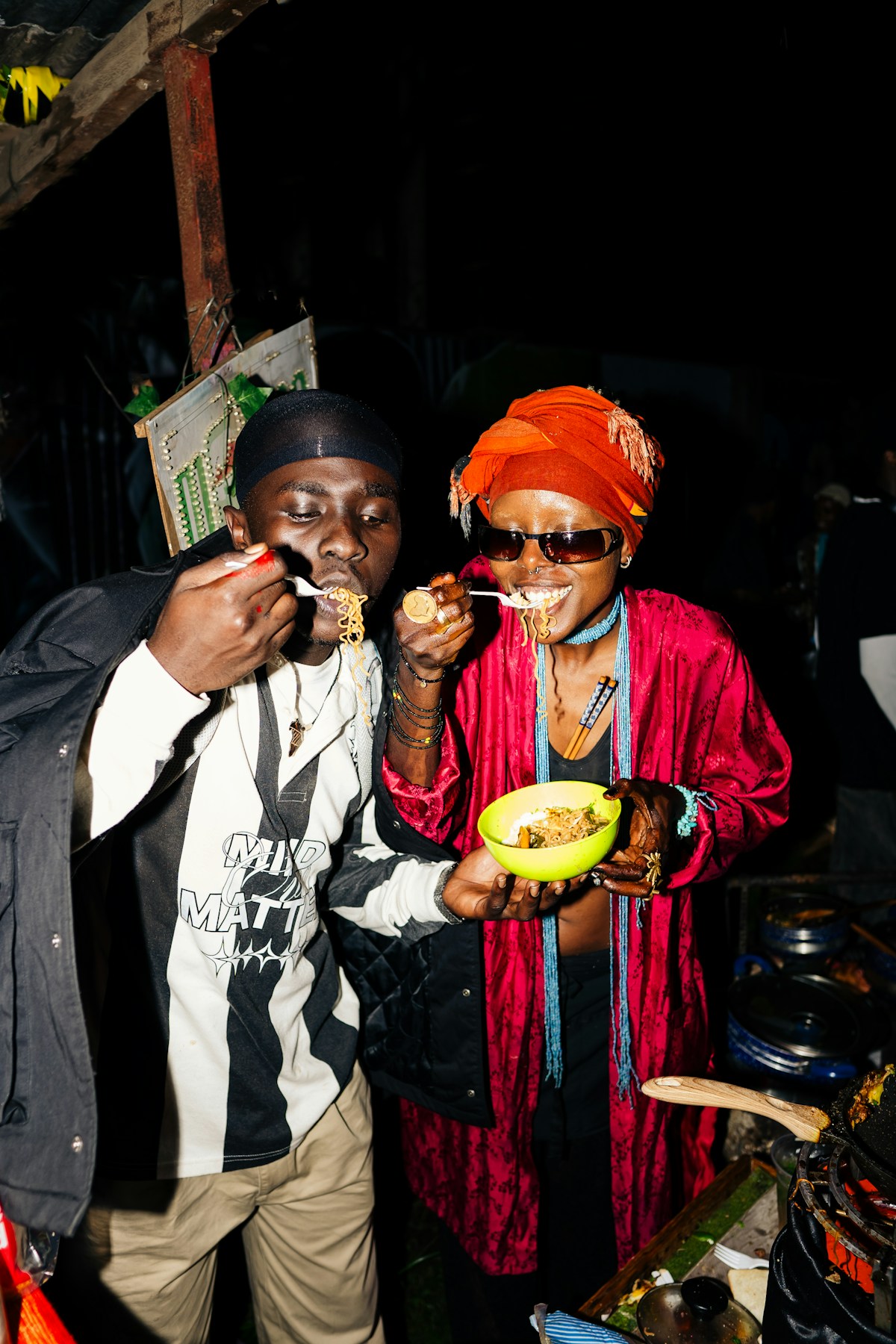 Two people enjoying street food at a Nairobi food stall, Kenya