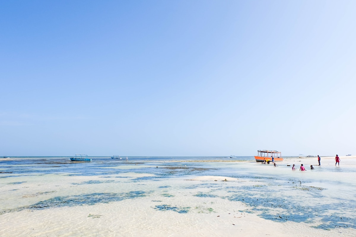 People on the shallow white sand beach at Malindi, Kenya coast