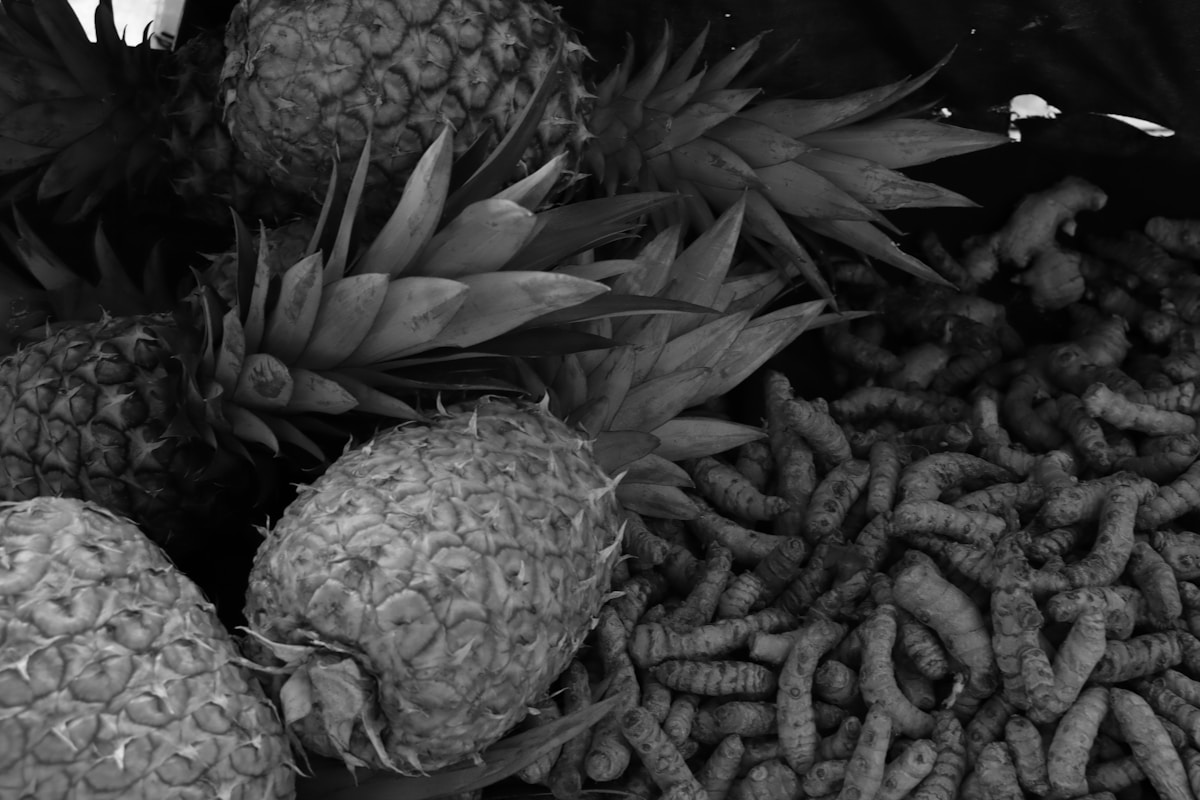 Fresh pineapples and turmeric root displayed at a Kenyan market