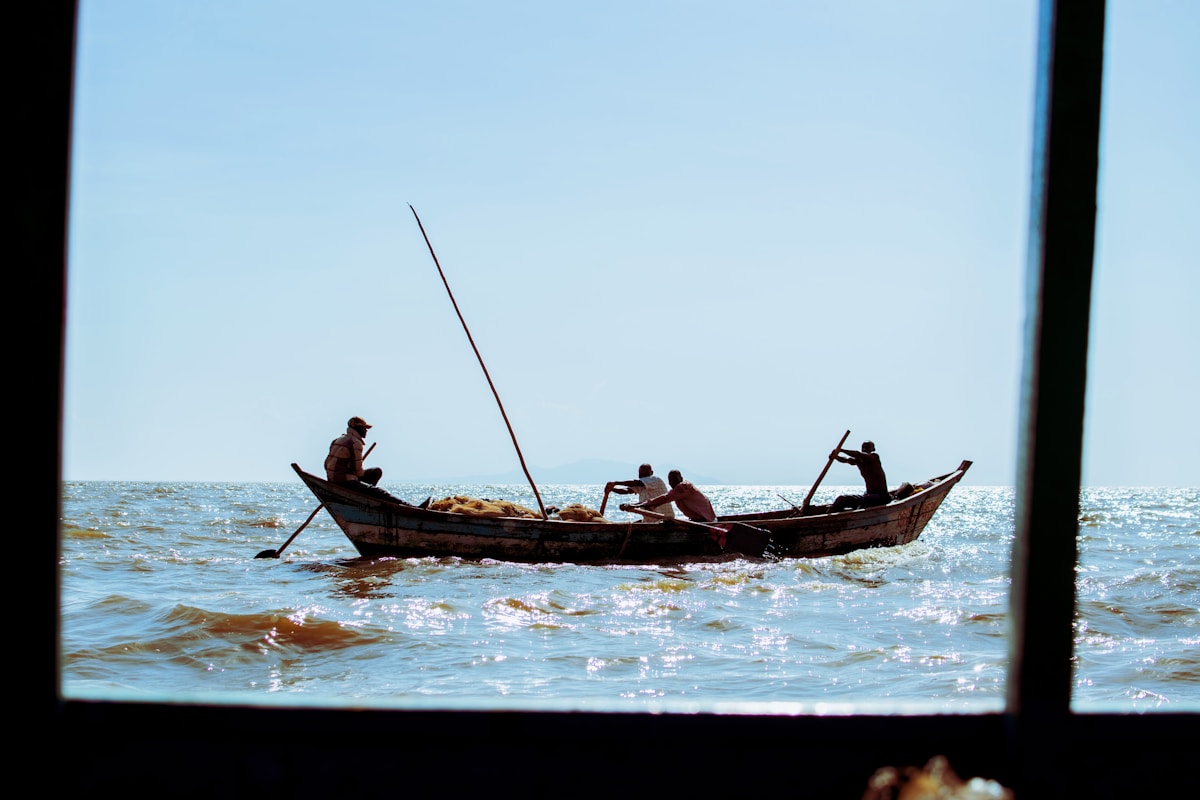 Fishermen rowing a wooden boat on Lake Victoria, Kisumu, Kenya