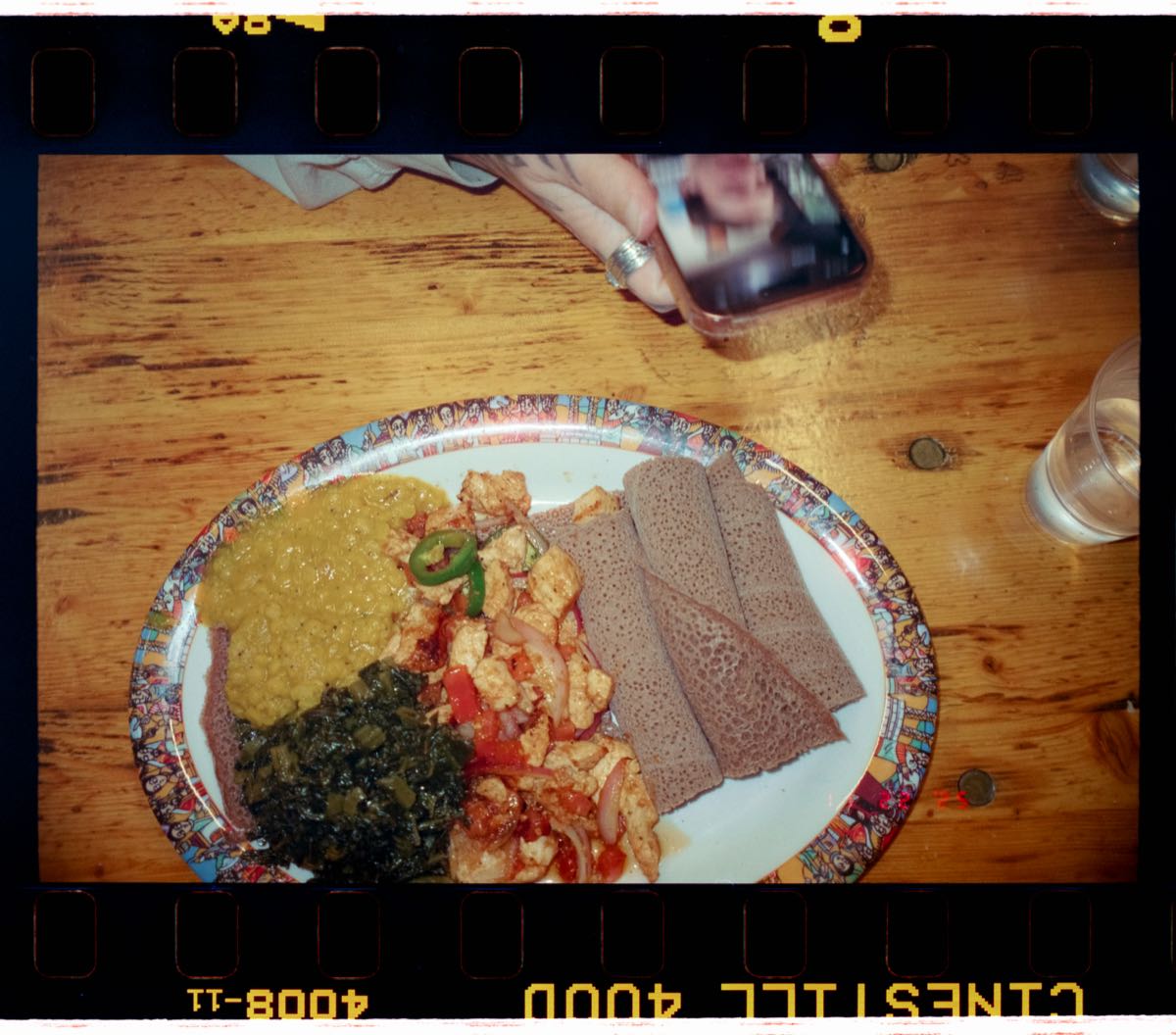 East African food platter with injera flatbread, lentil stew, and spiced vegetables