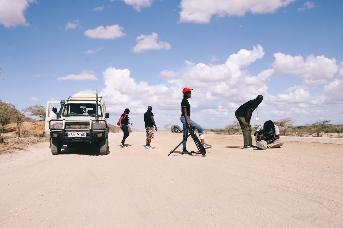Film crew with a Land Cruiser on a sandy road in the arid Turkana landscape, northern Kenya